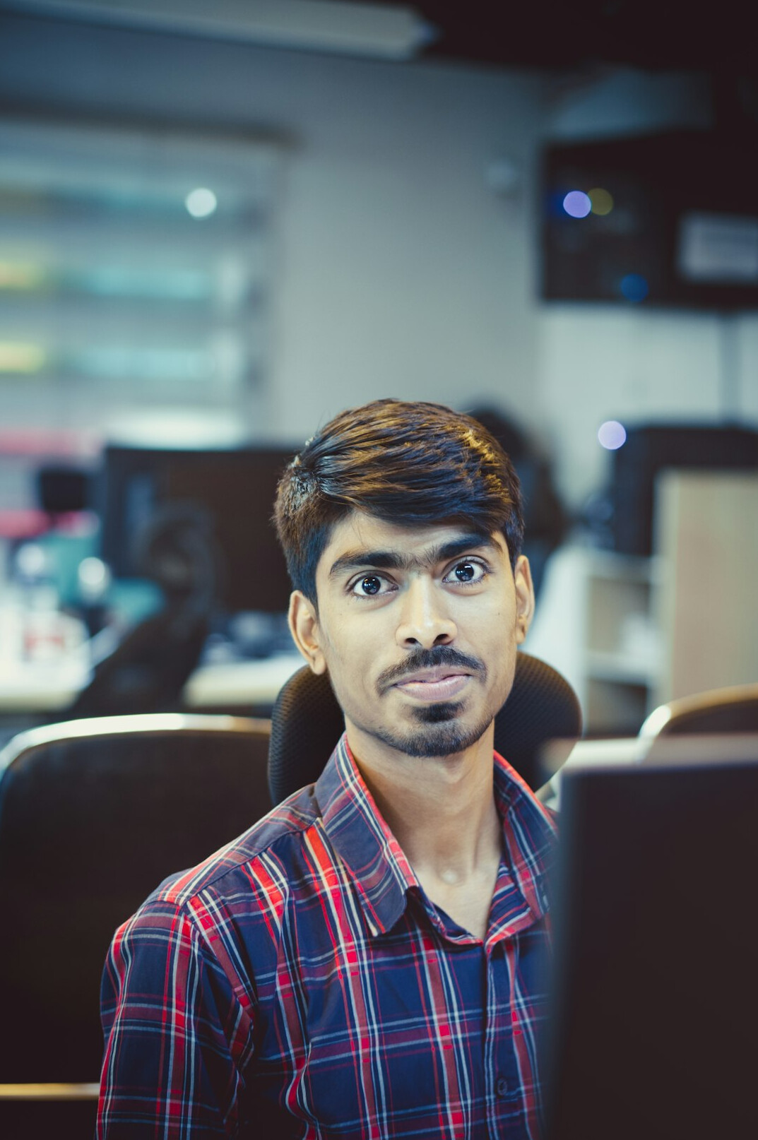 Developers working at laptops in a modern office